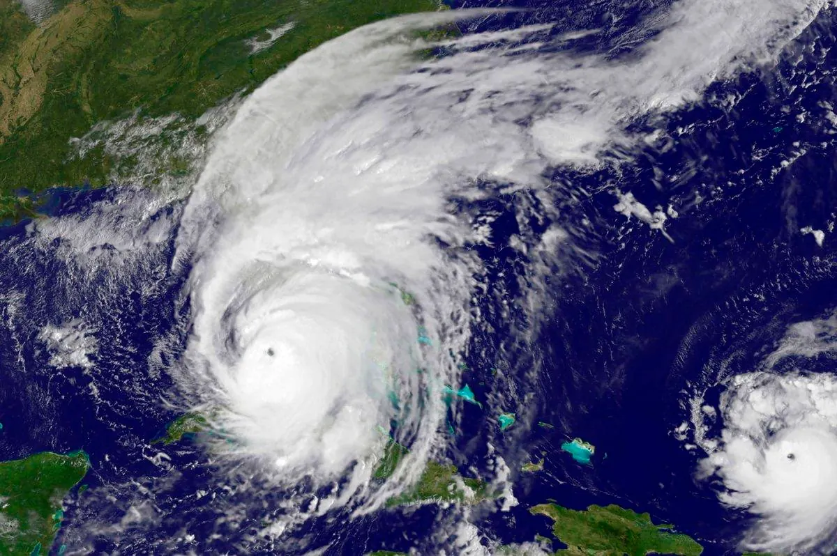 A satellite view of a large hurricane spanning the Straits of Florida as it approaches the southern tip of the peninsula.