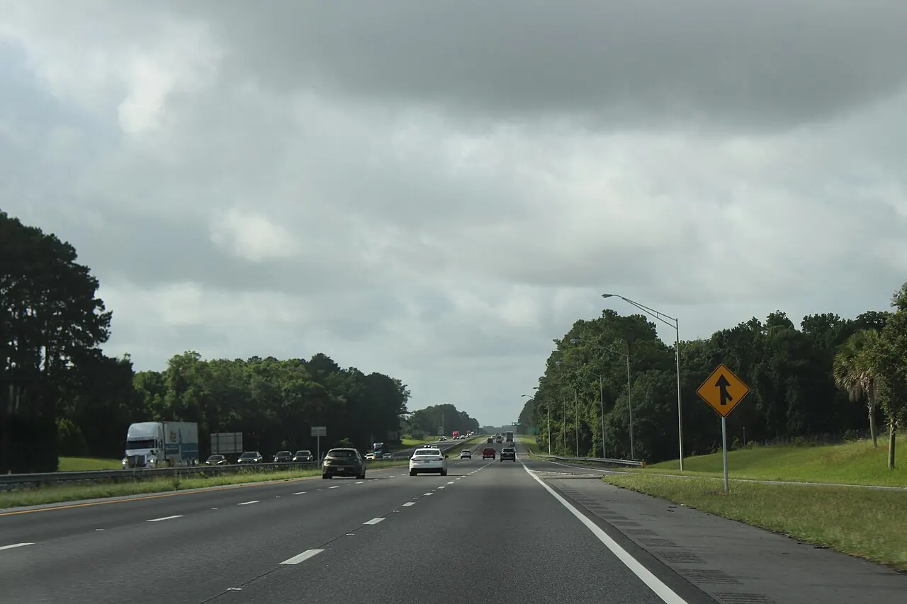 Interstate 75 running south through Marion County, three lanes of traffic between pine and scrub.
